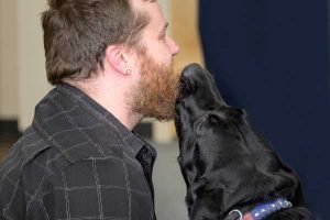 Veterans Moving Forward Service Dog Gives SteelCloud Employee a Kiss