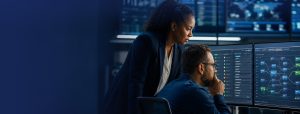 eMASS cybersecurity analysts reviewing a DoD authorization package in a security operations center